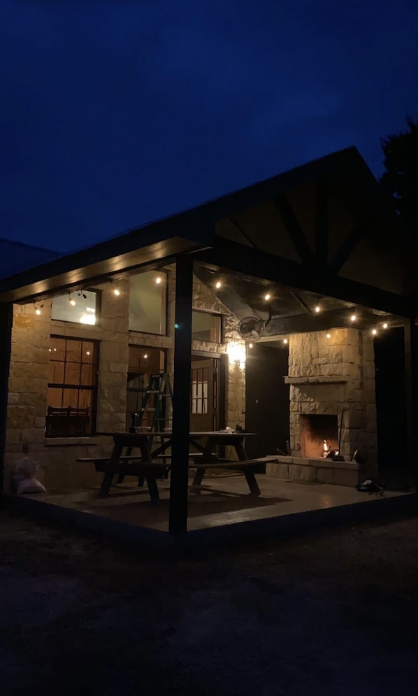 Covered patio with table and fireplace 