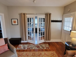 Beautiful french doors lead to the guest bedroom with privacy curtains