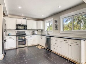 updated kitchen with beautiful views of the backyard