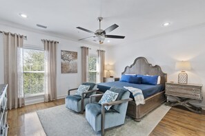 Large master bedroom suite with king sized bed and seating area on the 3rd floor