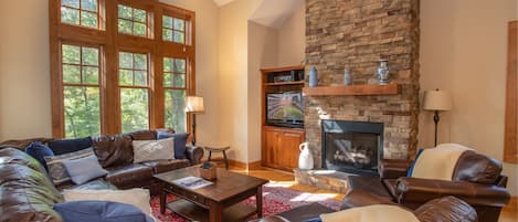 Great Room with Floor to Ceiling Stone Fireplace and Smart TV