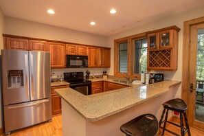 Modern Kitchen with granite counters and bar top seating