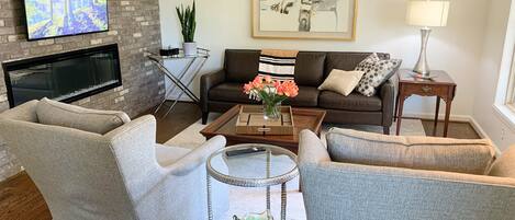 Living room with smart tv and electronic fireplace. 