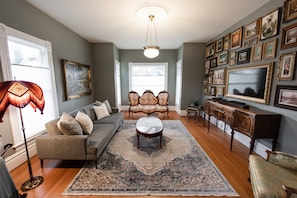 Living room with fold down couch and 50-in QLED 4K Samsung Frame TV