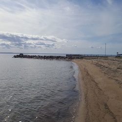 Sandy beach with dock and firepit