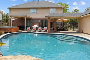 Luxurious outdoor pool, hot tub and seating area