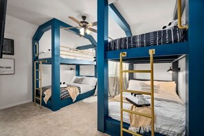 The Blue Room has 2 Bunk Beds and a TV mounted on the wall. Both are full over full mattresses. Each bed has fresh linens, towels, 4 pillows, and a Lamp w/ USB Plug.