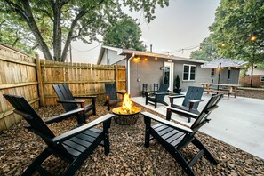 Fire pit with 6 Adirondack chairs. Firewood and s’more skewers included