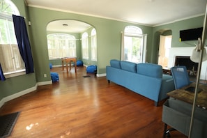 Living Room and Sun Room after stepping through the front door and turning left to briefly pass through the receiving room