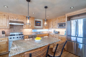 Granite counter tops, high end appliances and a spacious island allows for more than one top chef in the kitchen.