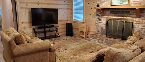 Lounge area #1, 65" Roku TV & sound bar/woofer (fireplace currently offline)