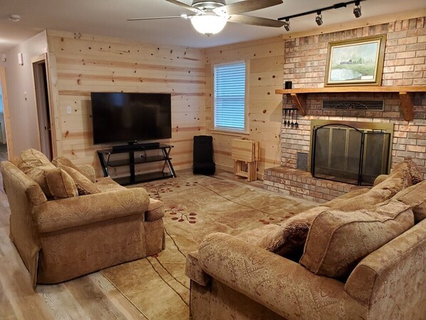 Lounge area #1, 65" Roku TV & sound bar/woofer (fireplace currently offline)