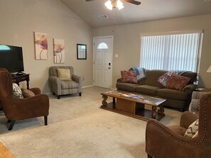 Seating for 7 in living room. Relax with a throw blanket.