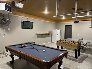 Garage game room with brand new thermostat-controlled heater & epoxy floors