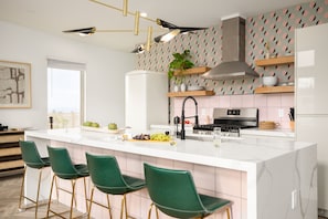 Kitchen features an island with countertop seating.