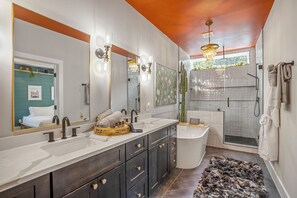 The master bath is wrapped with ceramic tile and features rain showerhead