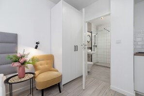 A small lounge area with a yellow chair and vibrant decor adding a cheerful touch.

