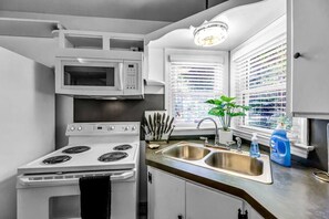 Bright Kitchen With Cooking Utensils and Pots/Pans