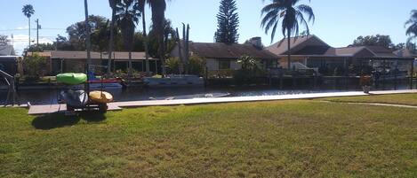 backyard with canal and kayaks