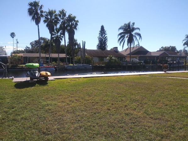 backyard with canal and kayaks