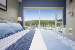 main bedroom, king size bed, tv and stunning view of the marina