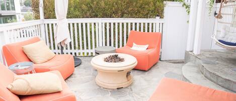 Front patio wth fire pit and swinging chair.  Next  to the outdoor patio.