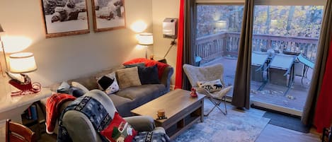 Family room with wood burning fireplace,  a sofa, a recliner and butterfly chair