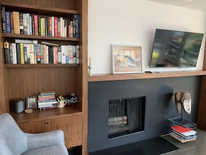The left hand bookshelf has a drop down shelf for an extra work space. 