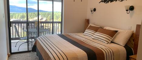 Downstairs bedroom. Door to balcony and mountain view. 