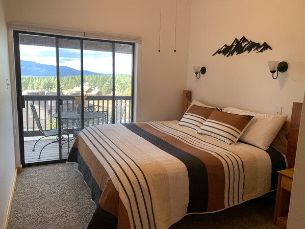 Downstairs bedroom. Door to balcony and mountain view. 