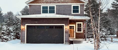 Two car garage, 4 Bedrooms,  3 flrs, small porch, and rear patio with a hot tub.