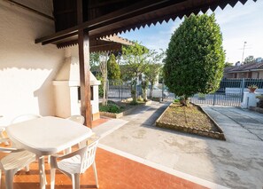 Garten. Der eingezäunte Garten mit Parkplatz und überdachter Terrasse