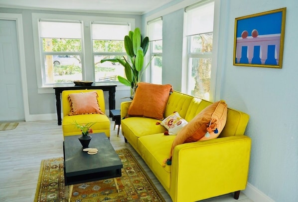 The living room with windows looking out onto the large front yard. So bright!