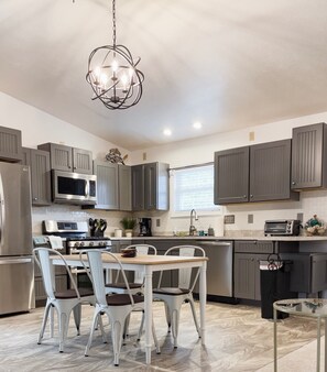 Updated kitchen stocked with cooking equipment for your meals while you stay