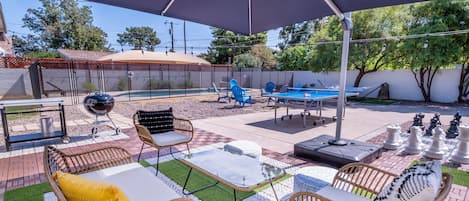 Relax in the backyard under the shade of a 12x12 ft. cantilever umbrella. 