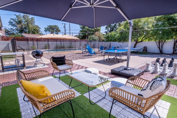 Relax in the backyard. Please note the umbrella is no longer available.