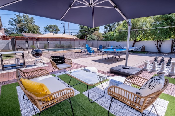 Relax in the backyard under the shade of a 12x12 ft. cantilever umbrella. 