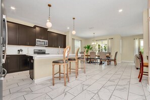 View of kitchen, bar, and dining room area