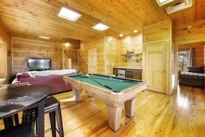Game room with theater area for movies or games. Enjoy a game of pool along with a wet bar for endless entertainment.