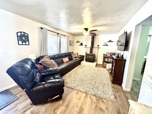 large  couch, recliner, smart tv, games, movies, dvd, electric fire place.