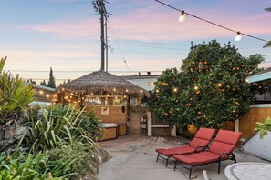 Market lights over patio at sunset.