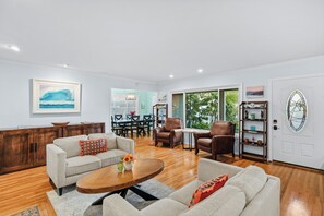 Large front sitting room with fireplace and unique art.