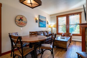 A warm and inviting living room with a gas fireplace, cable TV, and a sleeper sofa, perfect for relaxing or offering extra sleeping arrangements