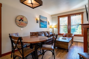 A warm and inviting living room with a gas fireplace, cable TV, and a sleeper sofa, perfect for relaxing or offering extra sleeping arrangements