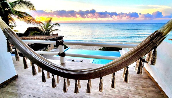 Relax in one of our hammocks with a perfect view of the pool and beach below.