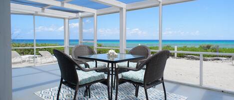 Oceanfront wrap around screened porch with panoramic Caribbean Sea view