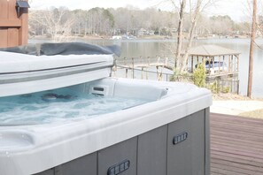 Hot tub with views of lake and access to all back patio amenities.
