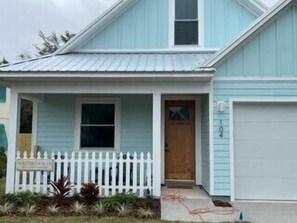 Adorable cottage with manicure lawns fenced in yard and heated pool