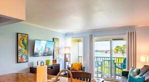 Open concept living area flows from the full kitchen, living area, and onto the private balcony overlooking the preserve and Old Tampa Bay