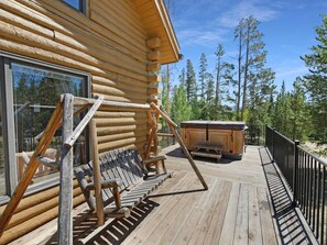 Front deck with swing and hot tub.